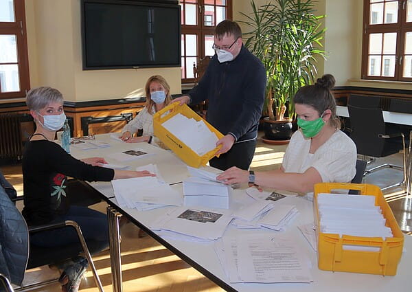 Mitarbeiter der Stadtverwaltung bereiten 4000 Serienbriefe vor, mit denen Bürger ab Montag über das neue Impfangebot der Stadt Freiberg informiert werden. Foto: Christian Möls
